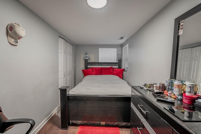 bedroom with dark hardwood / wood-style floors