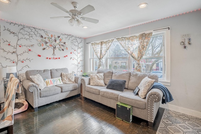 living room featuring dark wood-type flooring, plenty of natural light, and ceiling fan