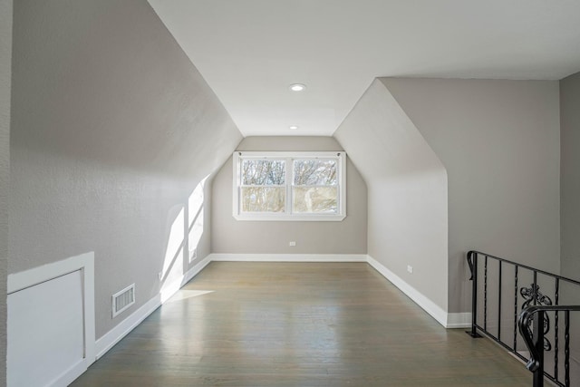 bonus room featuring wood-type flooring and vaulted ceiling