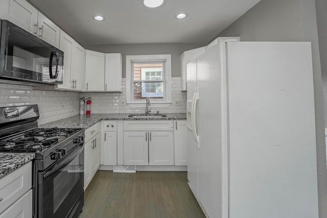 kitchen with white cabinetry, sink, dark hardwood / wood-style flooring, light stone counters, and black appliances