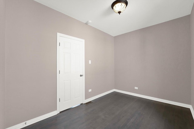 spare room with dark hardwood / wood-style floors