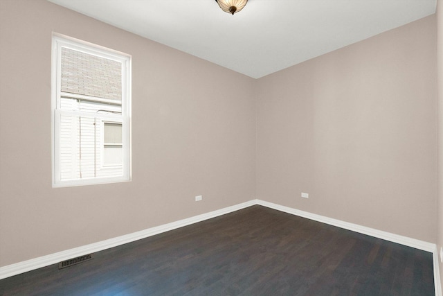 spare room with dark hardwood / wood-style floors