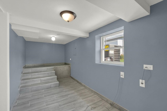 staircase featuring beam ceiling