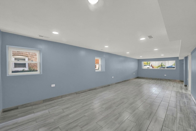 unfurnished room featuring plenty of natural light and light wood-type flooring