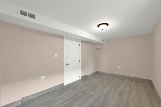 basement with hardwood / wood-style floors