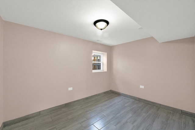 spare room featuring wood-type flooring