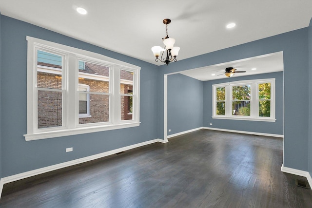 unfurnished room with dark hardwood / wood-style flooring and ceiling fan with notable chandelier