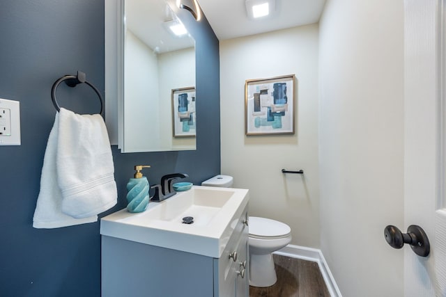 bathroom featuring hardwood / wood-style flooring, vanity, and toilet