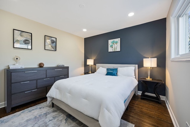 bedroom with dark hardwood / wood-style flooring