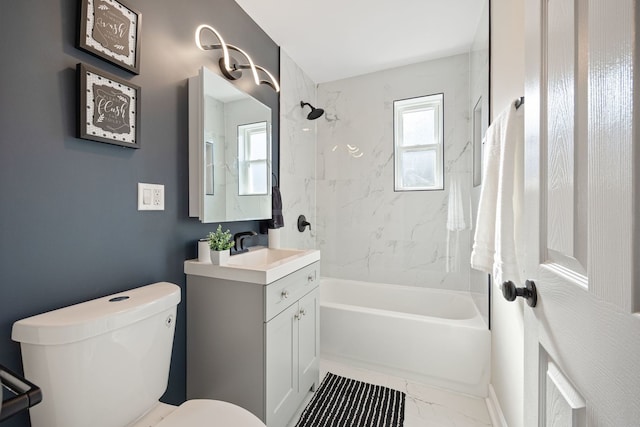 full bathroom featuring vanity, toilet, and tiled shower / bath combo