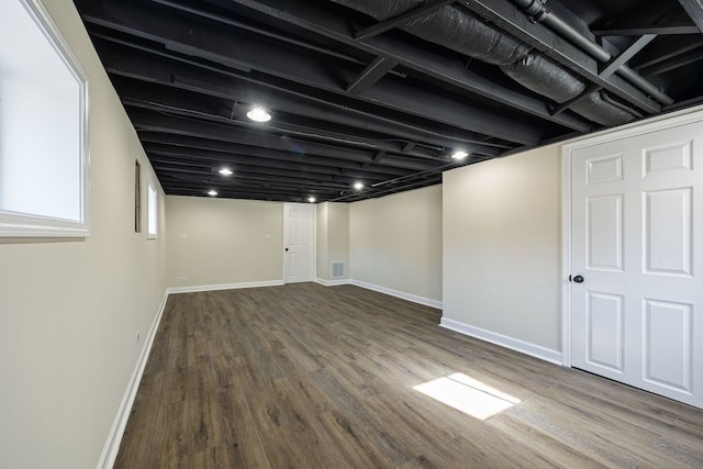 basement with hardwood / wood-style floors