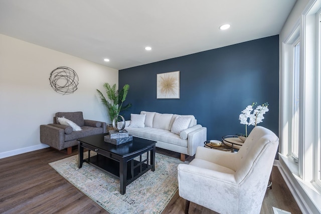 living room featuring a healthy amount of sunlight and dark wood-type flooring