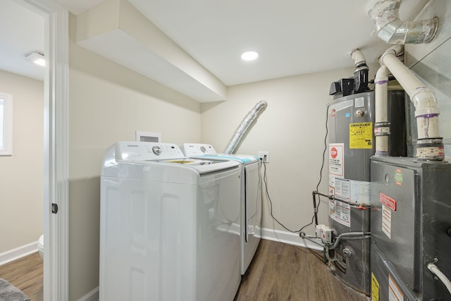 washroom featuring washer and dryer and dark wood-type flooring