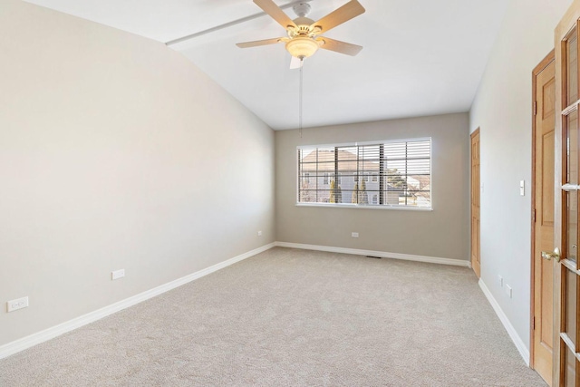 unfurnished room featuring light carpet, baseboards, lofted ceiling, and a ceiling fan