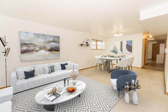 living room featuring light carpet and a chandelier