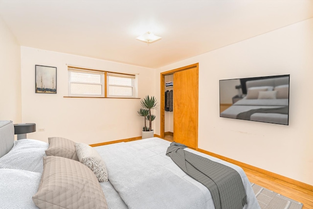 bedroom featuring wood-type flooring and a closet