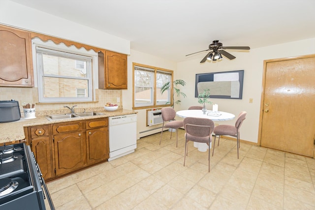 kitchen with sink, gas range, dishwasher, decorative backsplash, and a baseboard heating unit