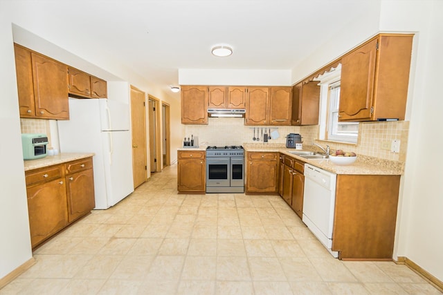 kitchen featuring tasteful backsplash, sink, and white appliances