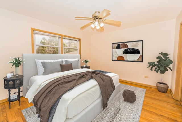 bedroom with light hardwood / wood-style floors and ceiling fan