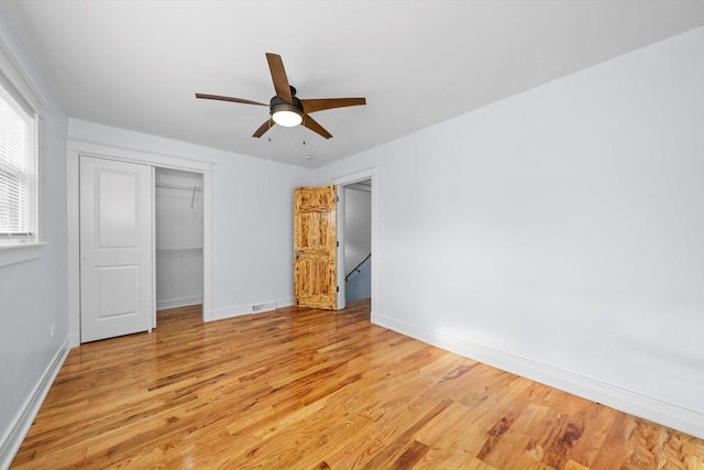 unfurnished bedroom featuring a closet, ceiling fan, and light wood-type flooring