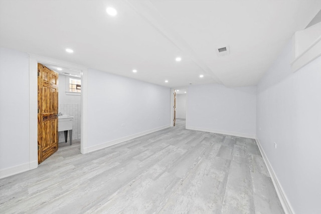 basement featuring light hardwood / wood-style flooring