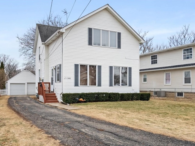 view of front of house featuring a garage, an outdoor structure, central AC, and a front lawn