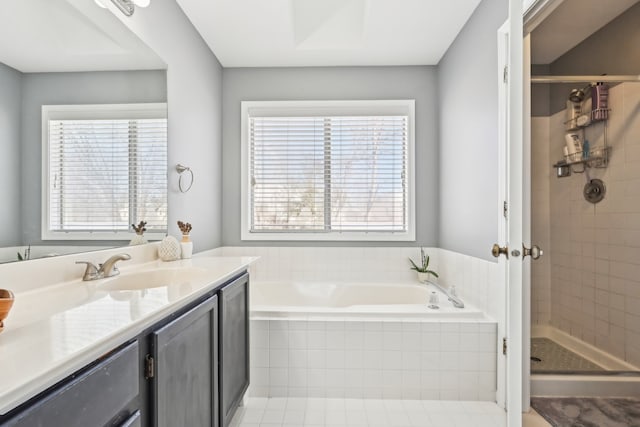 bathroom with a garden tub, plenty of natural light, and a stall shower