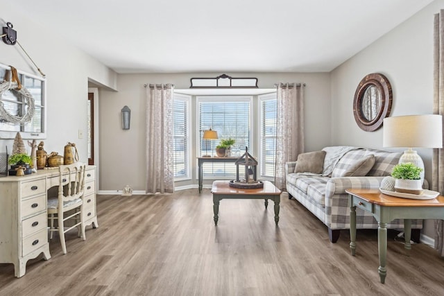 living area with wood finished floors and baseboards