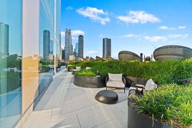 view of community featuring a patio area and a view of city