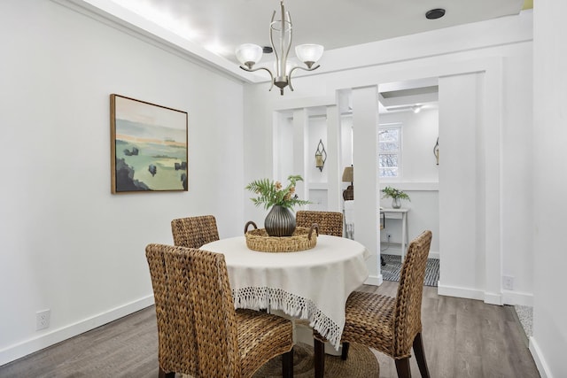 dining space featuring dark hardwood / wood-style floors and a notable chandelier