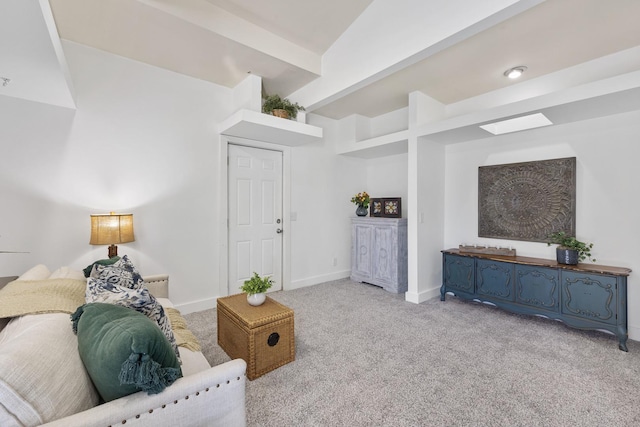 carpeted living room with beam ceiling