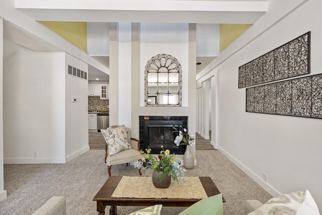 living room featuring carpet flooring and a fireplace