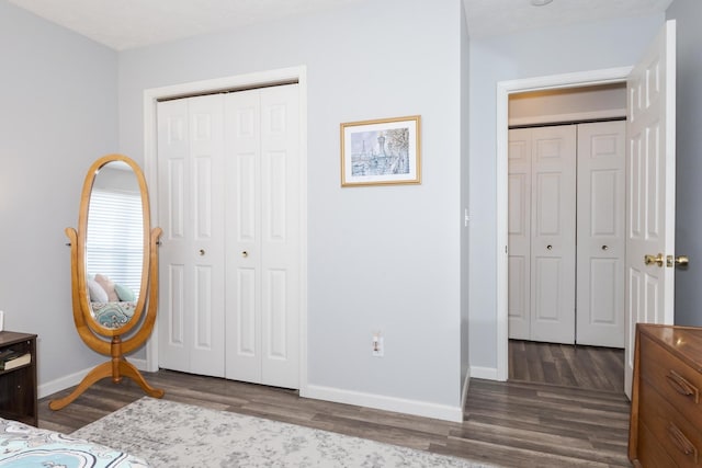 bedroom with dark wood-type flooring and a closet