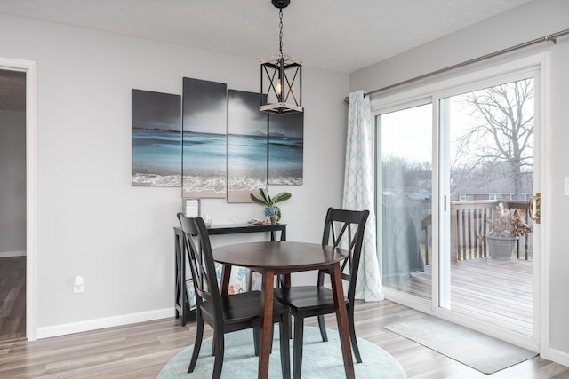 dining space with a textured ceiling and light wood-type flooring