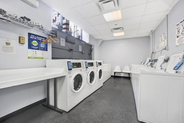 washroom featuring a wall mounted air conditioner and washer and clothes dryer