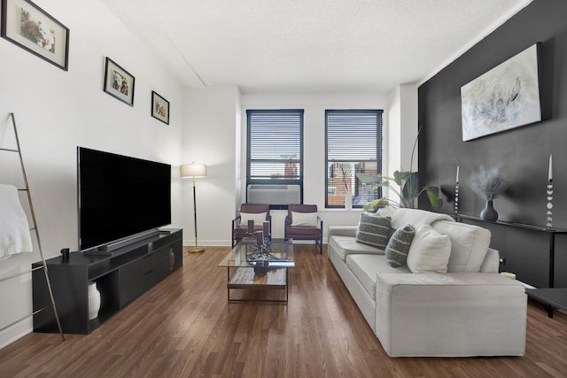 living room with dark wood-type flooring and a textured ceiling