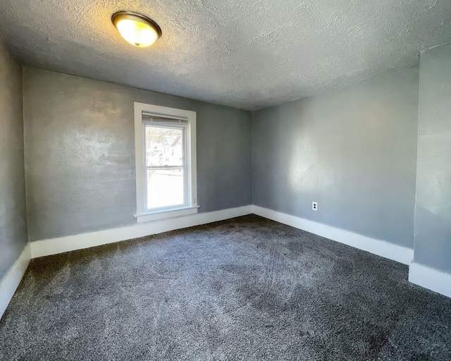 spare room with carpet floors and a textured ceiling