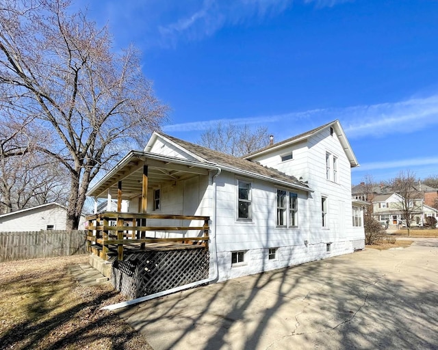 back of house featuring covered porch