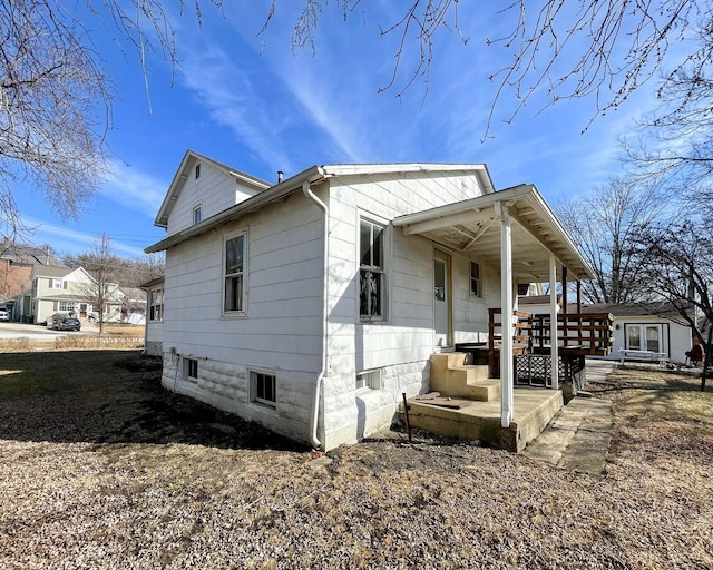 view of side of property featuring a porch