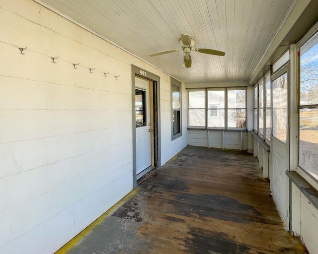 unfurnished sunroom with ceiling fan and wood ceiling