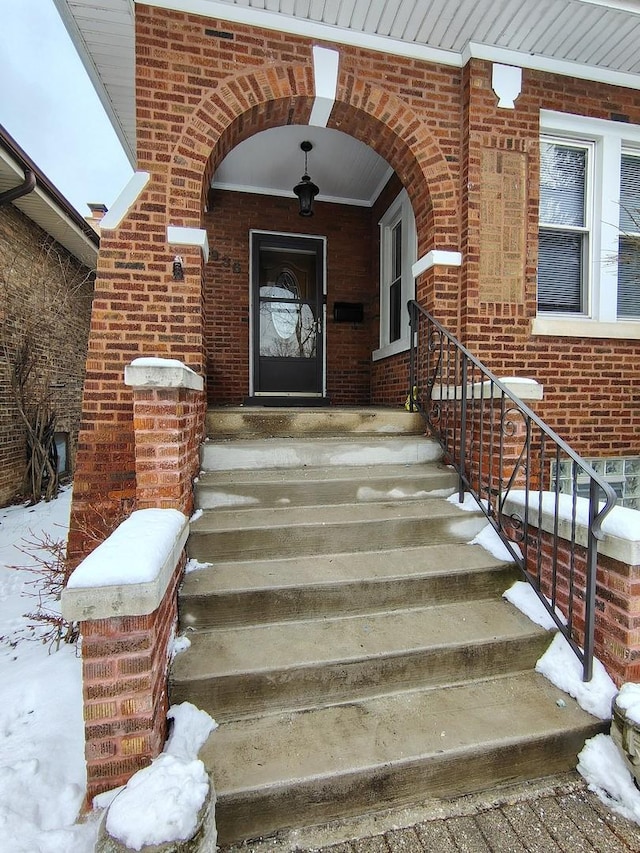 view of snow covered property entrance