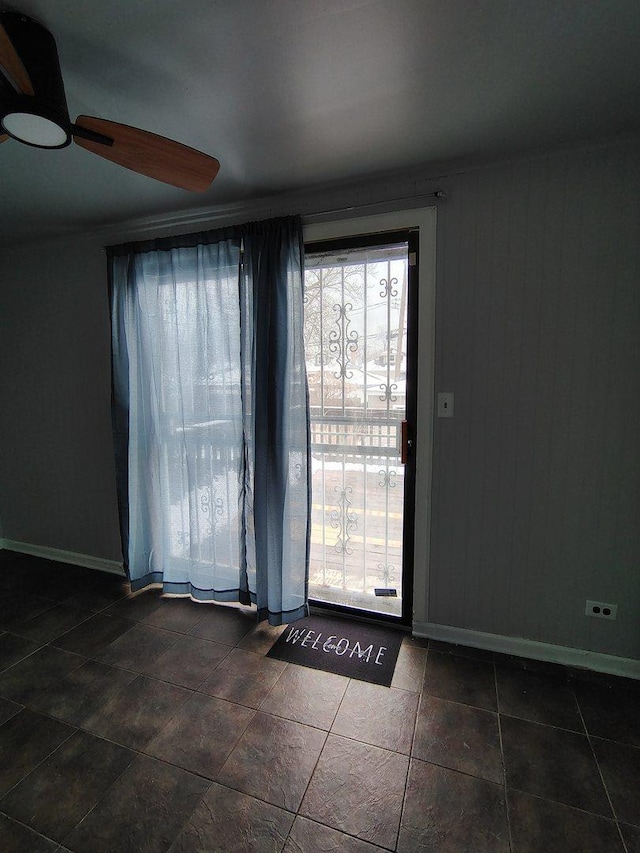 936 N Ridgeland Ave, Oak Park, IL 60302 - doorway featuring plenty of natural light, baseboards, ceiling fan, and dark tile patterned flooring
