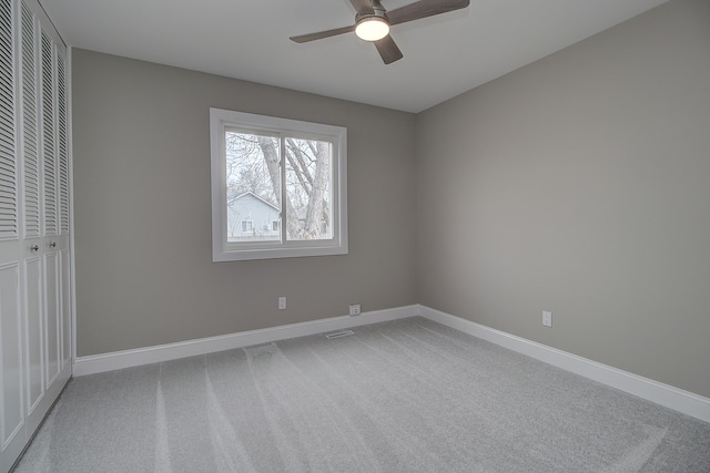 unfurnished bedroom with carpet, ceiling fan, and a closet