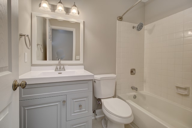 full bathroom featuring tiled shower / bath combo, vanity, and toilet