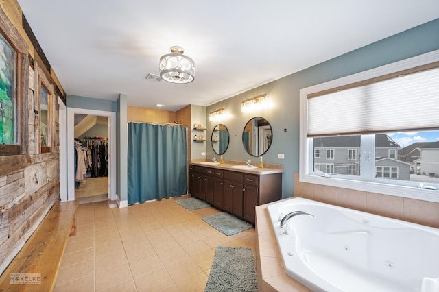 bathroom featuring double vanity, visible vents, tile patterned floors, a jetted tub, and a sink