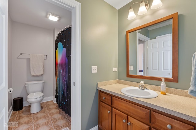 bathroom with toilet, vanity, baseboards, tile patterned floors, and an inviting chandelier