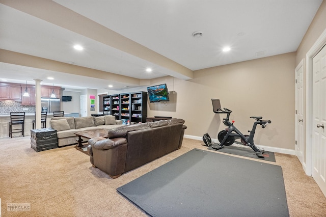 living room featuring recessed lighting, baseboards, and light colored carpet