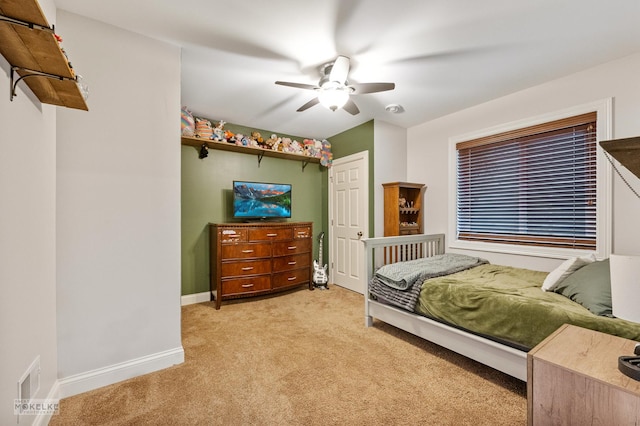 bedroom with baseboards, a ceiling fan, and light colored carpet