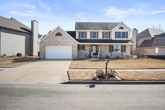 traditional home with a garage, cooling unit, brick siding, and driveway