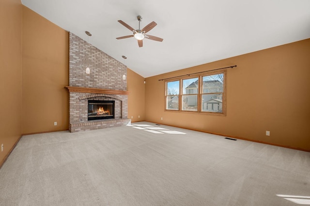 unfurnished living room featuring carpet, visible vents, a brick fireplace, high vaulted ceiling, and baseboards